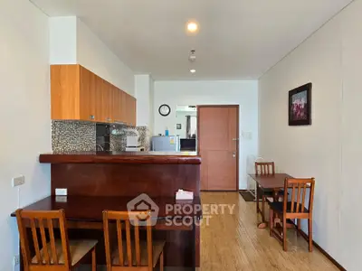 Charming open-layout kitchen and dining area with wooden accents and modern decor.