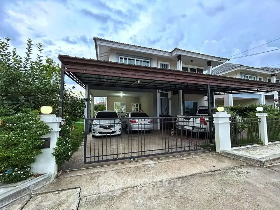 Charming suburban house with spacious driveway and lush greenery.