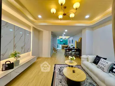 Luxurious open-plan living room with elegant decor and modern kitchen view.