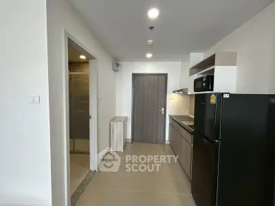 Modern apartment entrance with sleek kitchen and stylish cabinetry