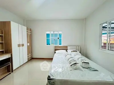 Spacious bedroom with modern furniture and natural light