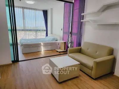 Modern studio apartment with wooden flooring and glass partition