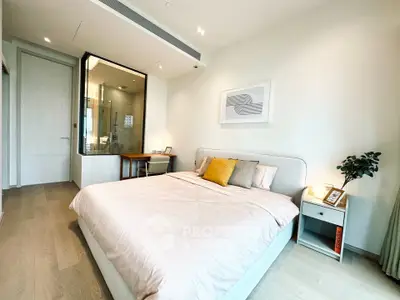 Modern bedroom with ensuite bathroom and stylish decor in a luxury apartment.