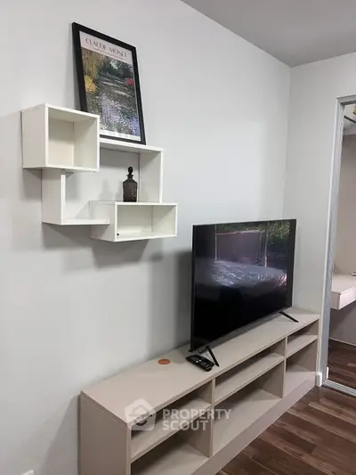 Modern living room with sleek TV stand and wall-mounted shelves, perfect for stylish urban living.