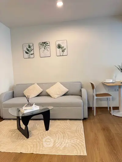 Modern living room with stylish decor, featuring a cozy sofa, elegant coffee table, and chic wall art.