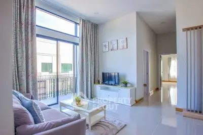 Spacious living room with elegant decor and large windows for natural light.