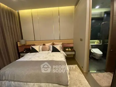 Luxurious bedroom with ensuite bathroom featuring modern design and ambient lighting.