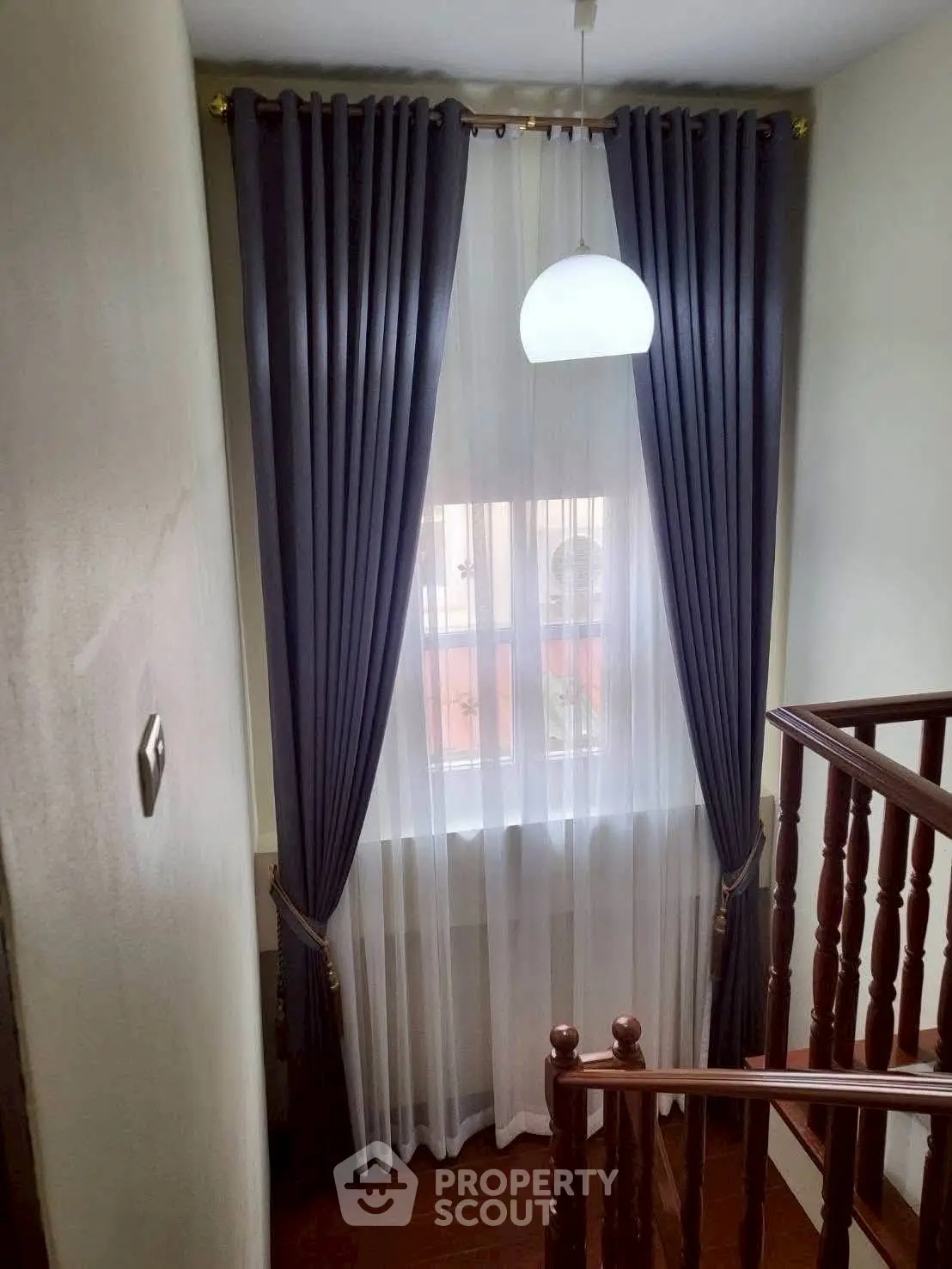 Elegant staircase with modern curtains and natural light