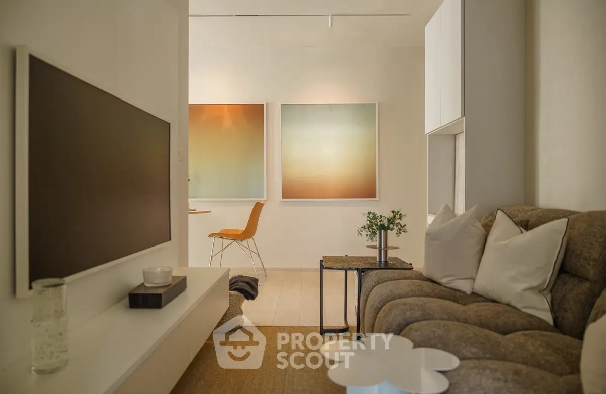 Stylish modern living room with cozy seating and contemporary art decor.