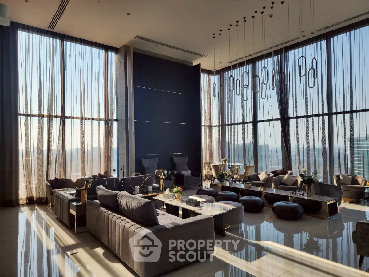Luxurious modern living room with floor-to-ceiling windows and elegant furnishings