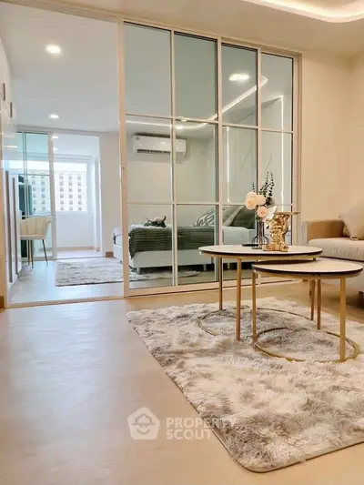 Modern living room with cozy decor and sliding glass doors to bedroom