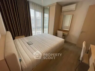 Modern bedroom with large window, air conditioning, and stylish furniture.