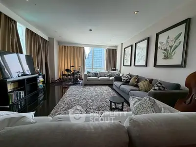 Spacious living room with modern decor and large windows offering city views.