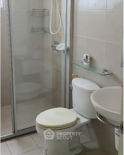 Compact bathroom with shower and toilet in modern apartment