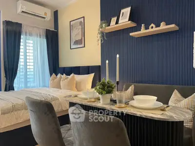 Stylish modern bedroom with elegant dining area and cozy decor