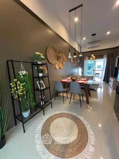 Stylish modern living room with dining area, featuring elegant decor and cozy ambiance.