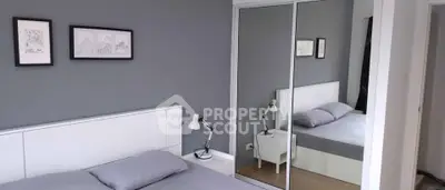 Modern bedroom with mirrored closet and stylish decor