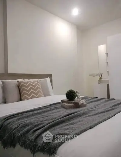 Cozy modern bedroom with stylish decor and soft lighting, perfect for relaxation.