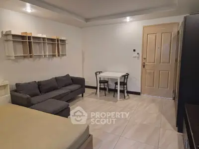 Cozy living room with modern furniture and stylish shelving, perfect for relaxation and entertaining.