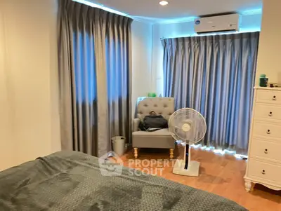 Cozy bedroom with elegant curtains and modern air conditioning unit