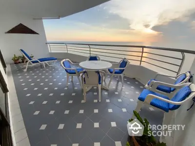 Stunning ocean view balcony with modern furniture and tiled flooring