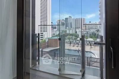 Stunning city view from a modern balcony overlooking a luxurious pool area.