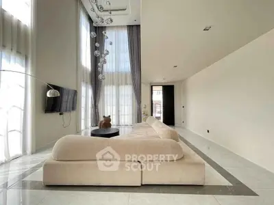 Luxurious modern living room with high ceilings and elegant decor