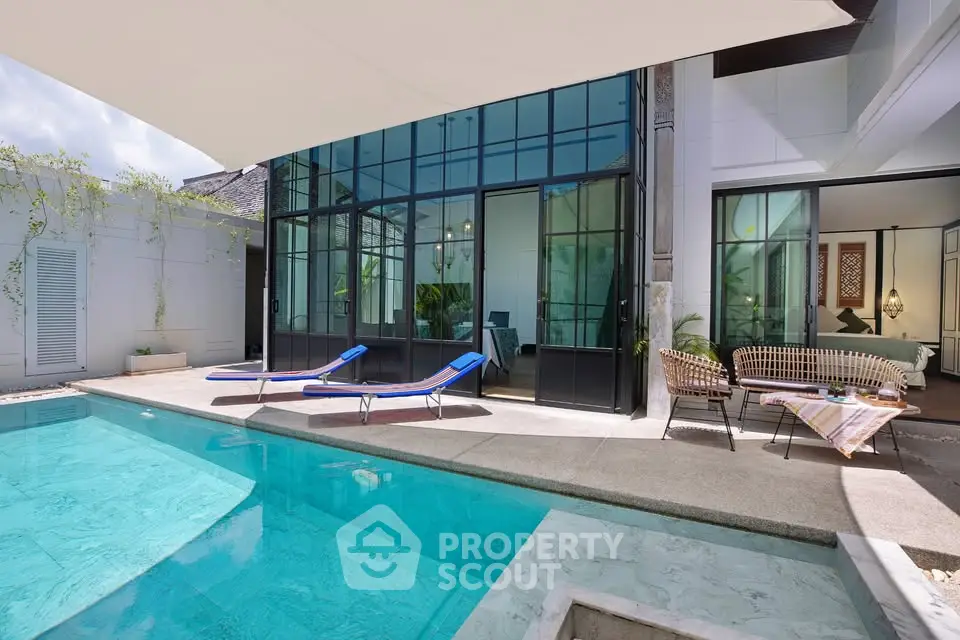 Luxurious modern villa with private pool and stylish outdoor seating area, perfect for relaxation and entertainment.