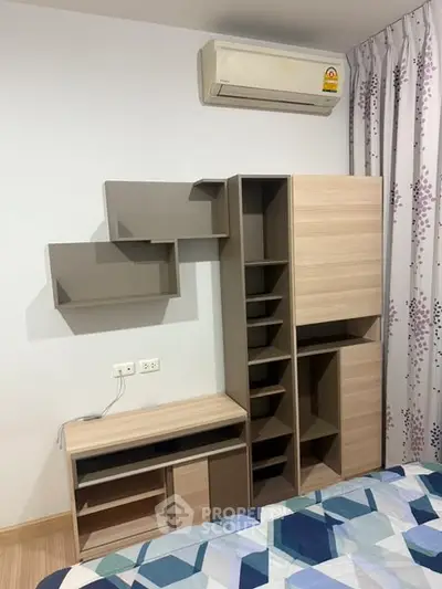 Modern bedroom with stylish storage and air conditioning