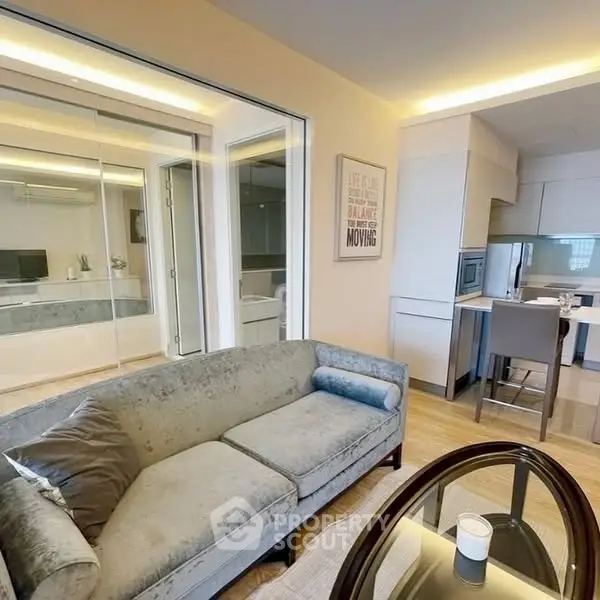 Modern living room with stylish furniture and open kitchen layout