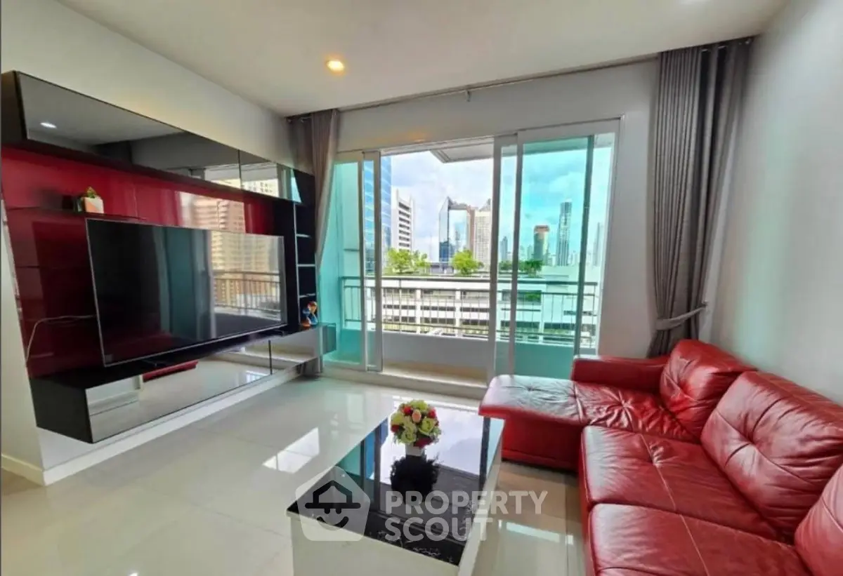 Modern living room with red leather sofa and city view balcony in luxury apartment.