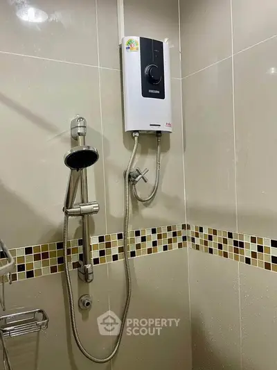 Modern bathroom with sleek shower and water heater, featuring stylish tile accents.