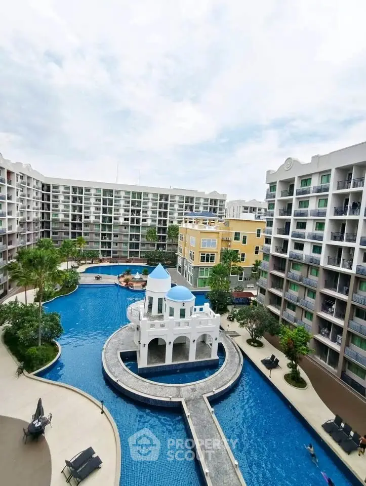 Luxurious condominium complex with stunning pool and modern architecture.