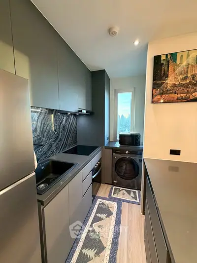 Modern kitchen with sleek cabinetry and city view window