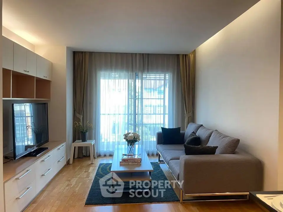 Modern living room with sleek furniture and large windows for natural light.