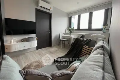 Cozy modern living room with stylish decor and natural light, perfect for relaxation and entertaining.