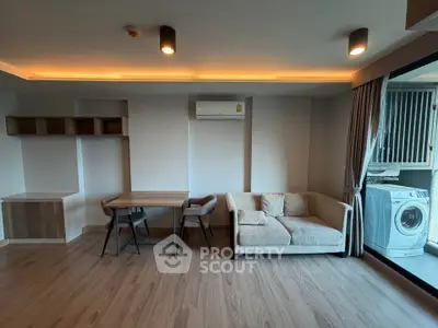 Modern living room with stylish furniture and washing machine on balcony