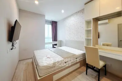 Modern bedroom with stylish decor, featuring a comfortable bed, wall-mounted TV, and elegant vanity desk.