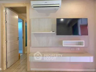 Modern living room with wall-mounted TV and air conditioning unit