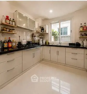 Spacious modern kitchen with sleek cabinetry and ample natural light.