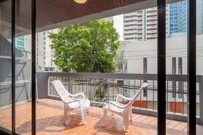 Spacious balcony with city view and seating, perfect for relaxation.