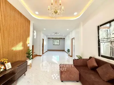 Spacious living room with elegant chandelier and modern decor