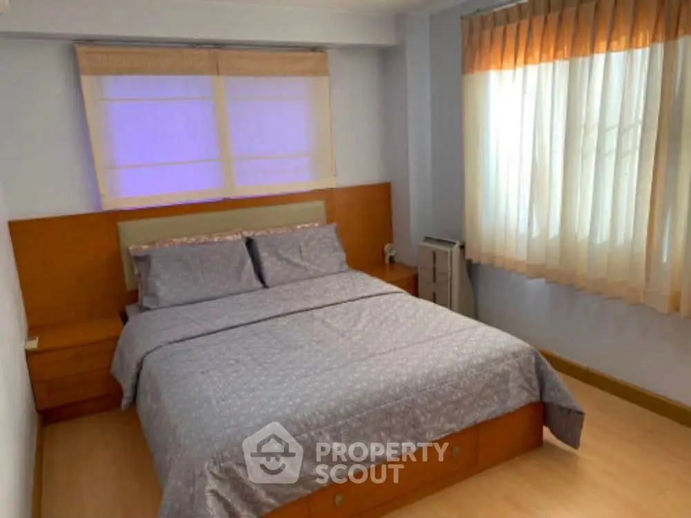 Cozy bedroom with natural light and modern furnishings, perfect for relaxation and comfort.