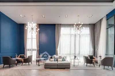Luxurious modern living room with elegant chandeliers and plush seating in a spacious interior.
