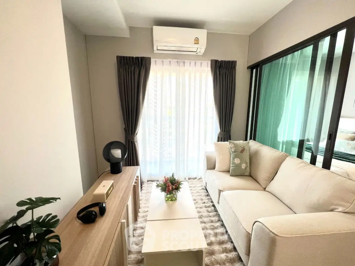 Cozy living room with modern decor and natural light, featuring a plush sofa and stylish curtains.