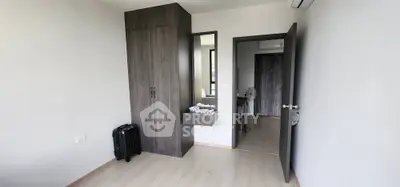 Modern bedroom with sleek wardrobe and minimalist decor, perfect for urban living.