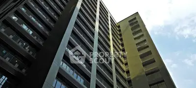 Modern high-rise building with sleek architectural design and expansive windows.