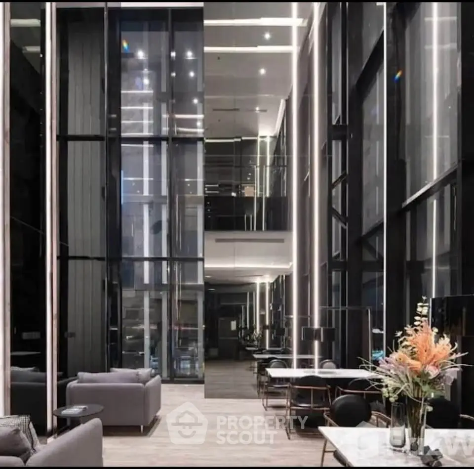 Luxurious modern lobby with high ceilings and elegant decor in a contemporary building.