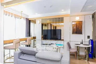 Modern living room with stylish decor and large TV, featuring a cozy seating area and elegant dining space.