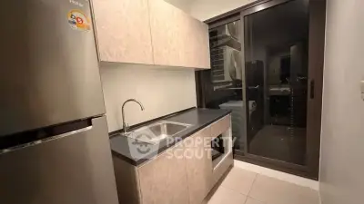 Modern kitchen with sleek cabinetry and stainless steel appliances in a compact layout.